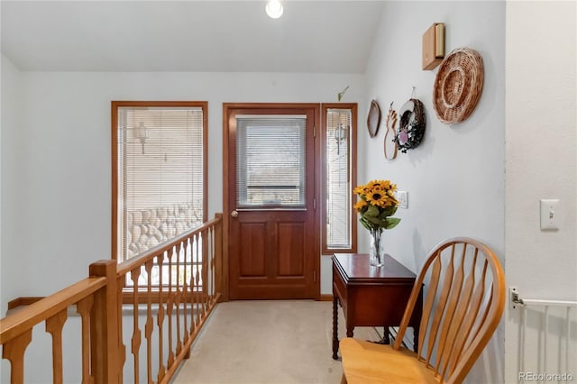 foyer entrance featuring light carpet