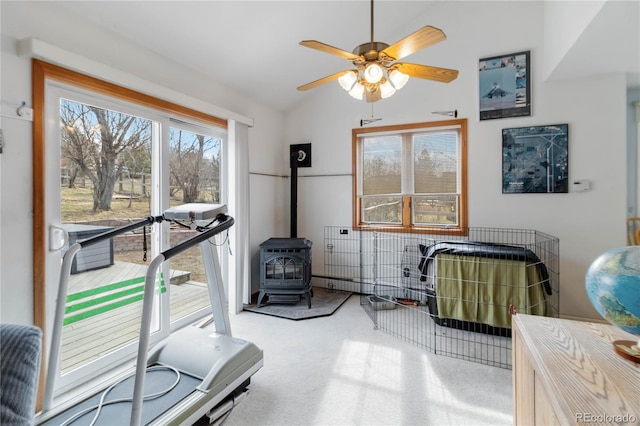 workout room featuring a ceiling fan, lofted ceiling, and carpet