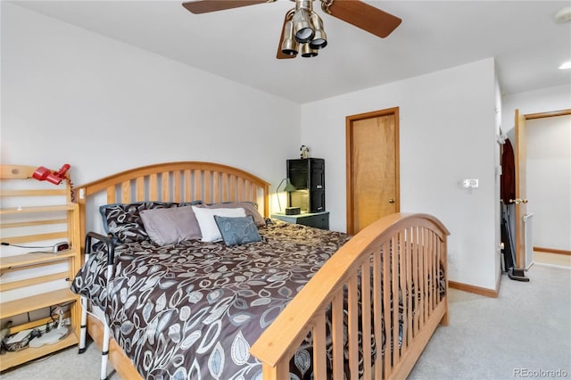 carpeted bedroom featuring baseboards and ceiling fan