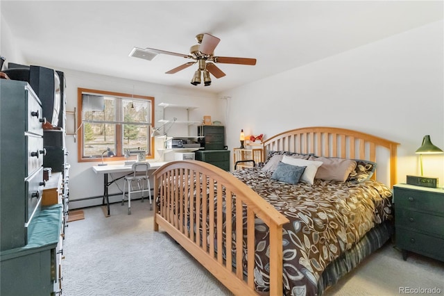 bedroom featuring a baseboard heating unit, carpet floors, and a ceiling fan