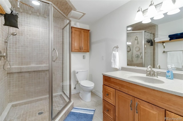 bathroom with vanity, tile patterned floors, toilet, and a shower stall