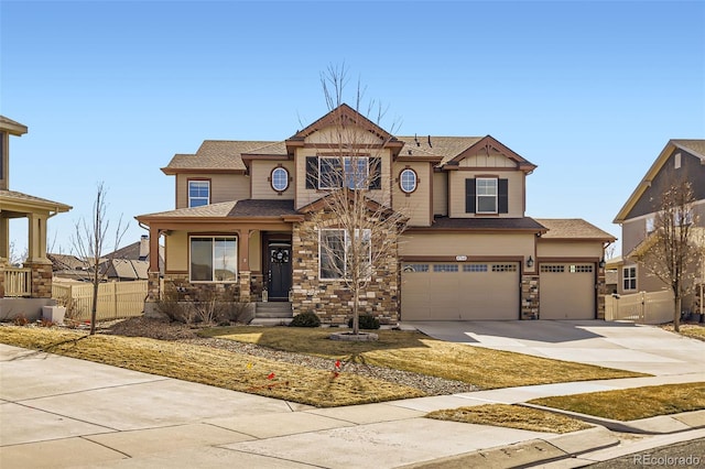 craftsman house with an attached garage, a shingled roof, fence, concrete driveway, and stone siding