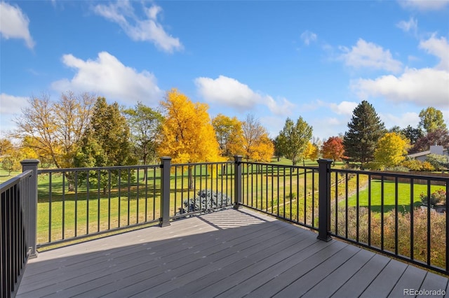 wooden terrace featuring a lawn