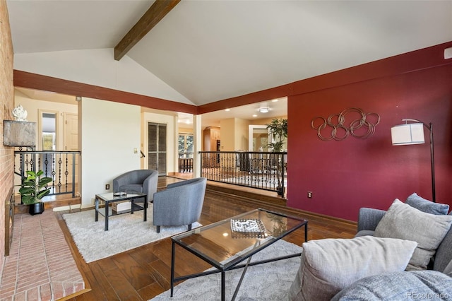 living room featuring a wealth of natural light, hardwood / wood-style floors, and lofted ceiling with beams