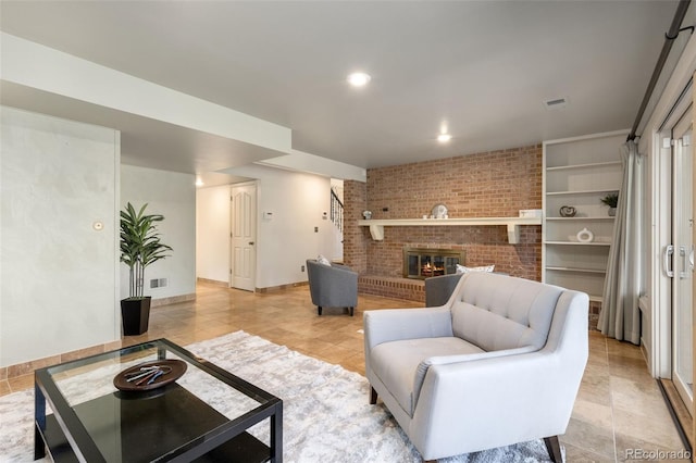 tiled living room featuring a brick fireplace