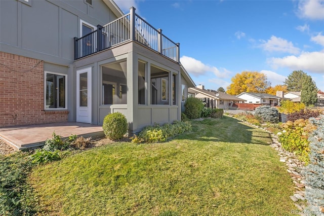 view of yard featuring a patio and a balcony