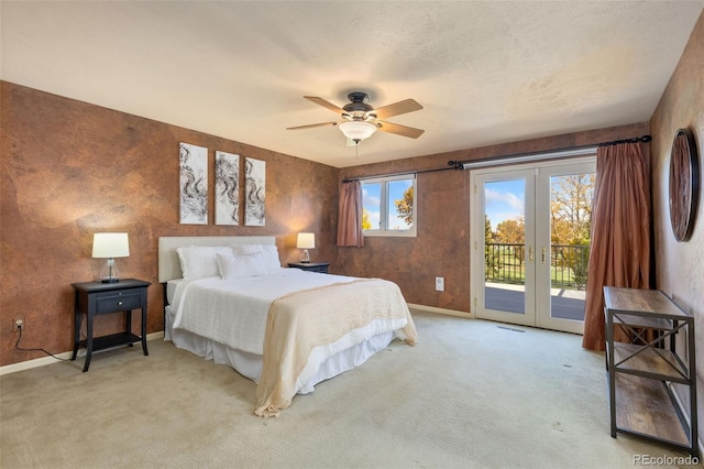 bedroom with french doors, a textured ceiling, access to exterior, ceiling fan, and light carpet