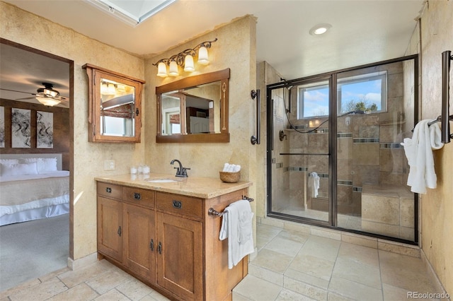 bathroom featuring vanity, ceiling fan, and walk in shower