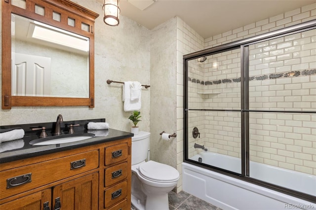 full bathroom with vanity, combined bath / shower with glass door, toilet, and tile patterned floors