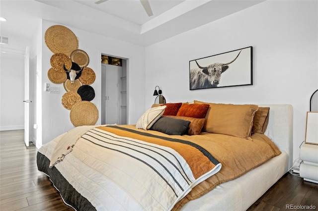 bedroom with recessed lighting, wood finished floors, a spacious closet, and visible vents