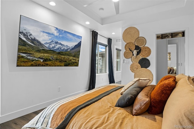 bedroom featuring visible vents, baseboards, recessed lighting, dark wood-type flooring, and a raised ceiling
