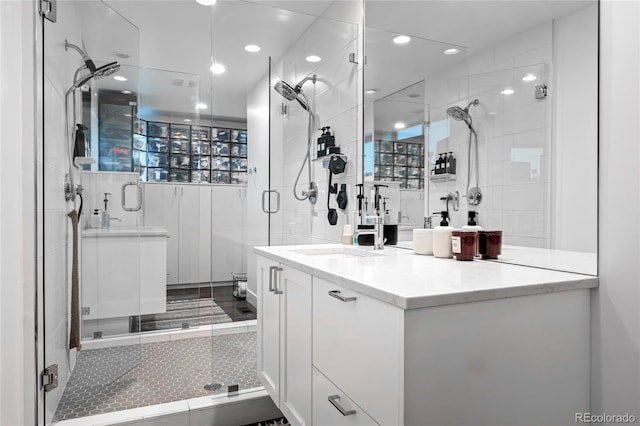 bathroom with recessed lighting, a shower stall, and vanity