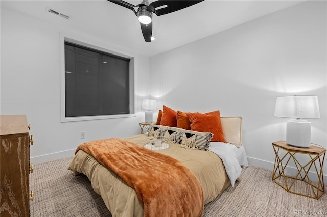 carpeted bedroom featuring baseboards, visible vents, and ceiling fan