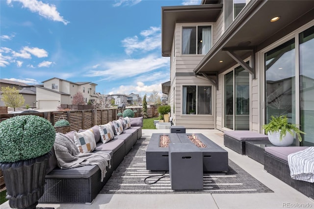view of patio / terrace featuring a residential view, a fenced backyard, and an outdoor living space with a fire pit