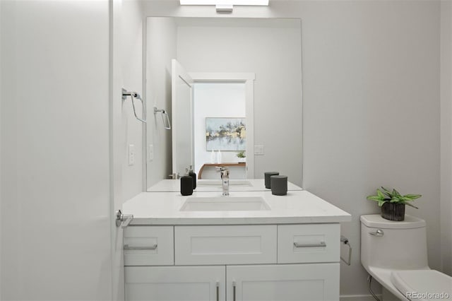 bathroom featuring vanity and toilet