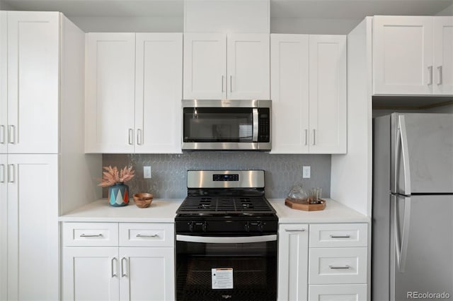 kitchen featuring decorative backsplash, stainless steel appliances, and white cabinets