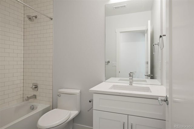 full bathroom featuring tiled shower / bath combo, vanity, and toilet