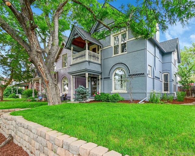 444 S Pearl St, Denver, CO 80209 - victorian-style house featuring a balcony, a chimney, brick siding, and roof with shingles