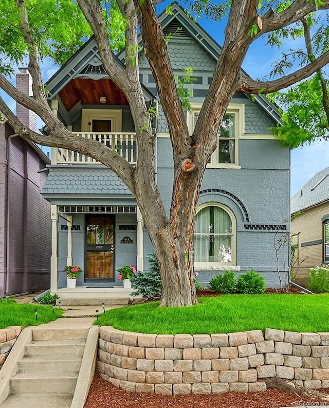 444 S Pearl St, Denver, CO 80209 - view of front of house featuring a balcony, brick siding, and a porch