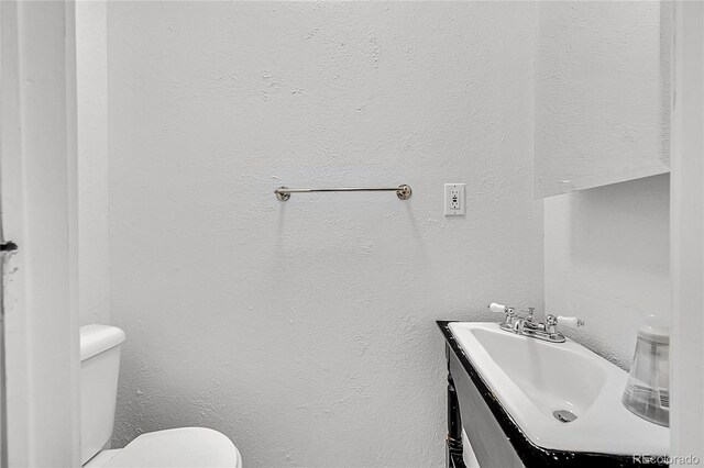 444 S Pearl St, Denver, CO 80209 - half bath featuring vanity and a textured wall
