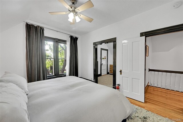 444 S Pearl St, Denver, CO 80209 - bedroom featuring a barn door, light wood-style flooring, and ceiling fan
