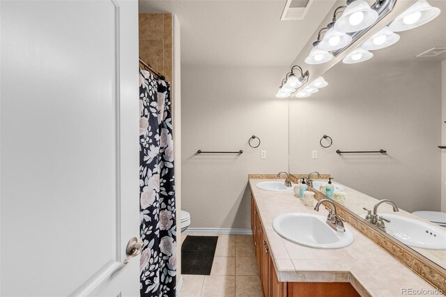 full bath featuring visible vents, a sink, and double vanity