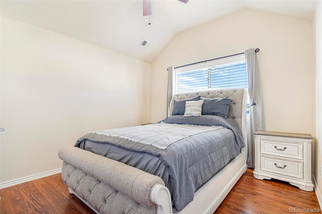 bedroom featuring lofted ceiling, dark wood-style floors, baseboards, and visible vents