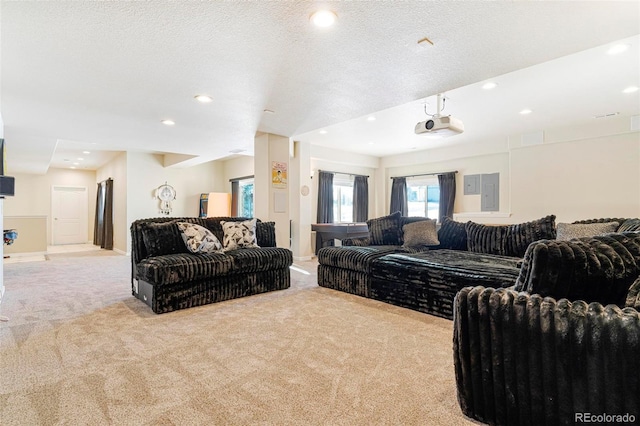 living room featuring a textured ceiling, recessed lighting, and light colored carpet