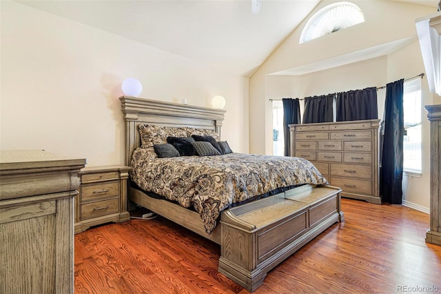 bedroom featuring lofted ceiling and dark wood-type flooring