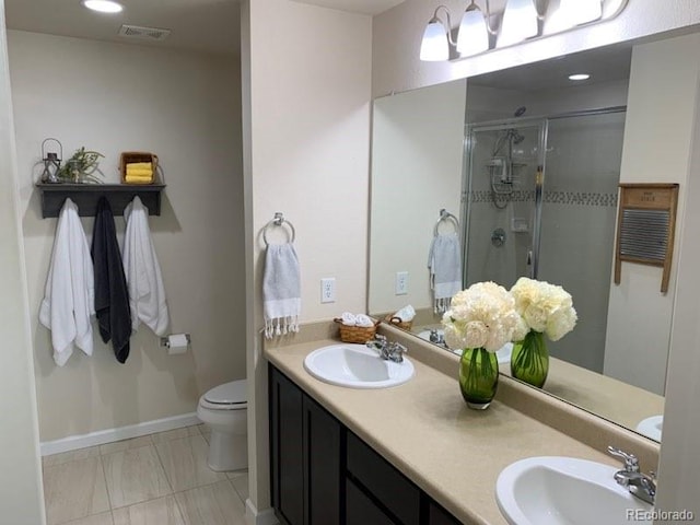 bathroom with double sink vanity, an enclosed shower, tile patterned flooring, and toilet