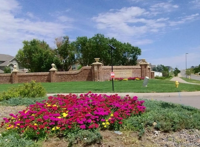 community / neighborhood sign with a lawn