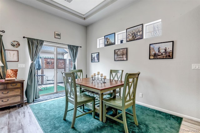 5519 Genoa St, Denver, CO 80249 - dining space featuring wood finished floors and a high ceiling