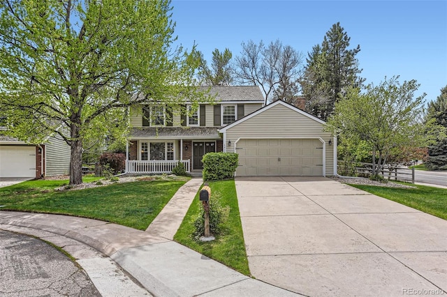 traditional home with covered porch, a front yard, brick siding, concrete driveway, and an attached garage