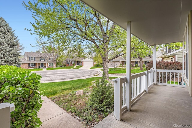 exterior space with covered porch and a residential view