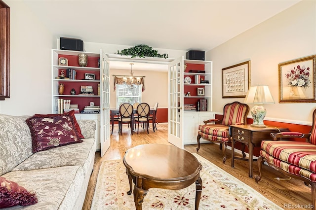 living room with a chandelier and light wood-style floors
