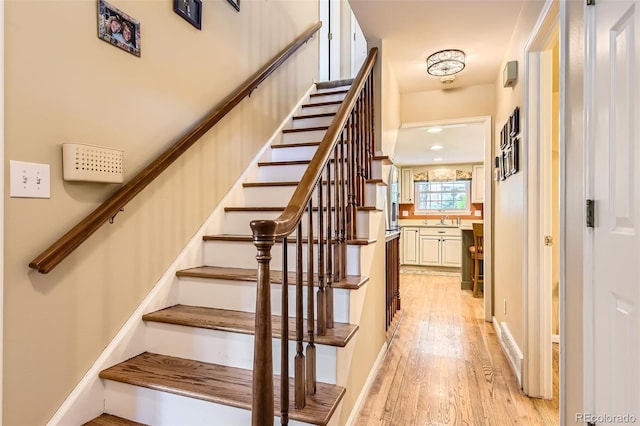 stairway featuring wood finished floors