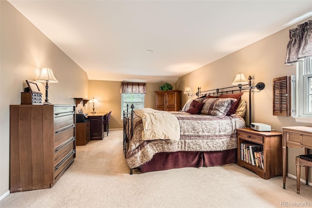 bedroom with baseboards and light carpet
