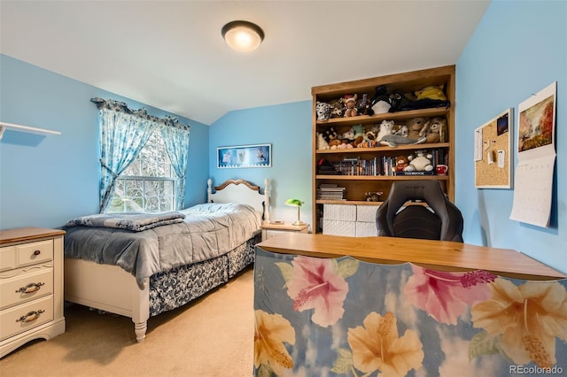bedroom with light colored carpet and lofted ceiling