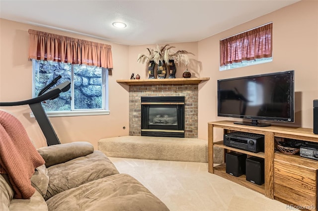 carpeted living area with recessed lighting and a fireplace