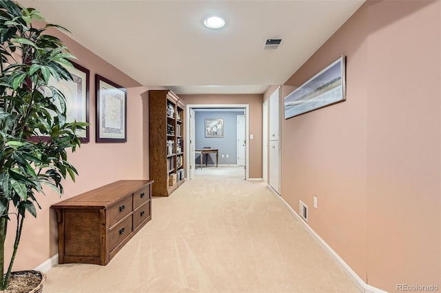 hallway with baseboards, light carpet, recessed lighting, and visible vents