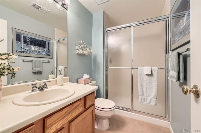full bathroom featuring toilet, visible vents, a shower stall, and vanity