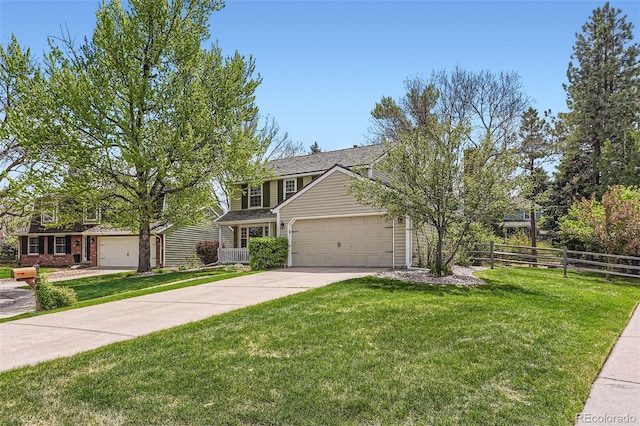 traditional-style house with a garage, fence, a front yard, brick siding, and concrete driveway