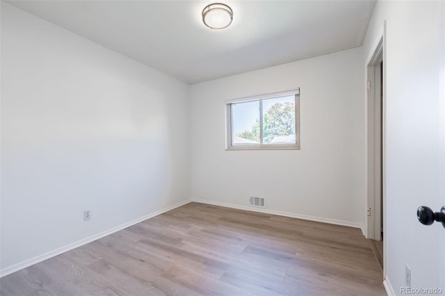 spare room featuring light hardwood / wood-style flooring