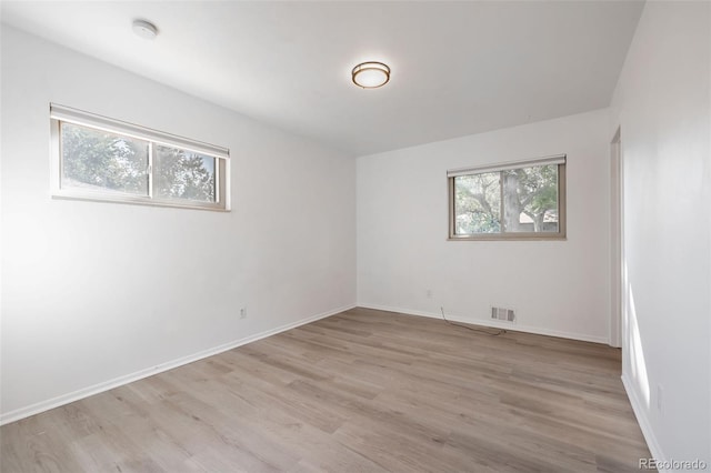 empty room with light hardwood / wood-style floors