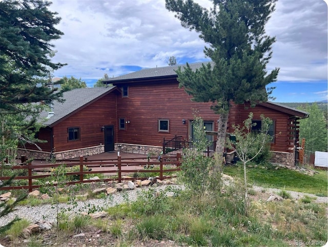 1666 High Creek Rd, Fairplay, CO 80440 - back of house featuring stone siding, a deck, and a shingled roof