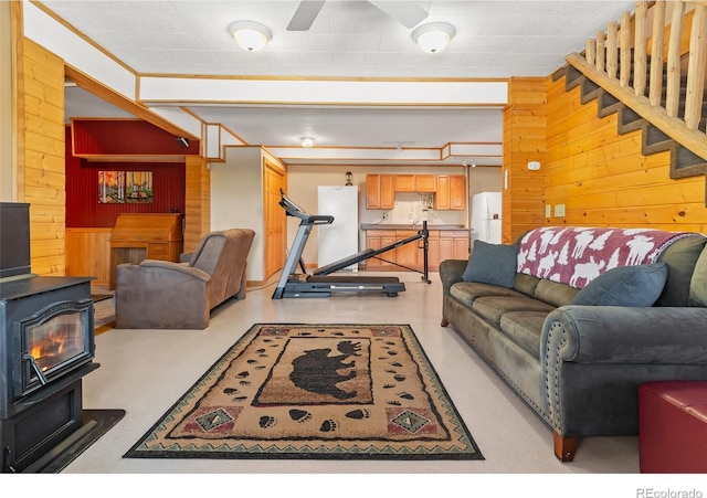 1666 High Creek Rd, Fairplay, CO 80440 - living area with a wood stove, wooden walls, and stairs