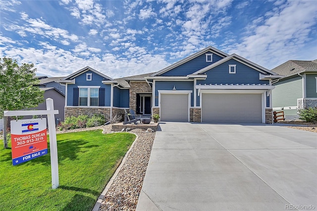 craftsman-style home featuring a garage and a front yard