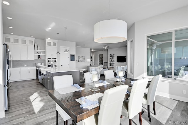 dining space featuring light hardwood / wood-style floors and ceiling fan