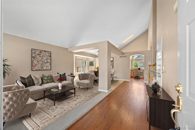 8985 Edgewood Ln, Highlands Ranch, CO 80130 - living area featuring wood-type flooring, baseboards, and high vaulted ceiling