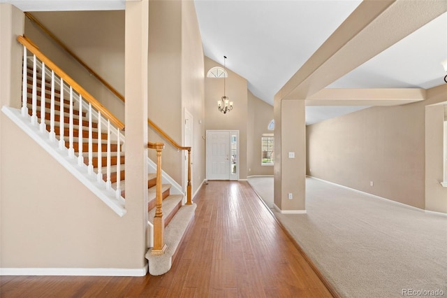 8985 Edgewood Ln, Highlands Ranch, CO 80130 - foyer featuring baseboards, stairs, a chandelier, wood finished floors, and high vaulted ceiling